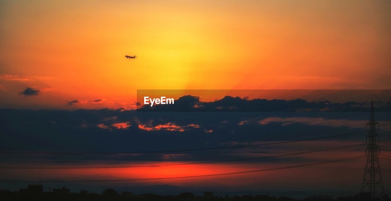 SILHOUETTE BIRDS FLYING OVER ORANGE SKY