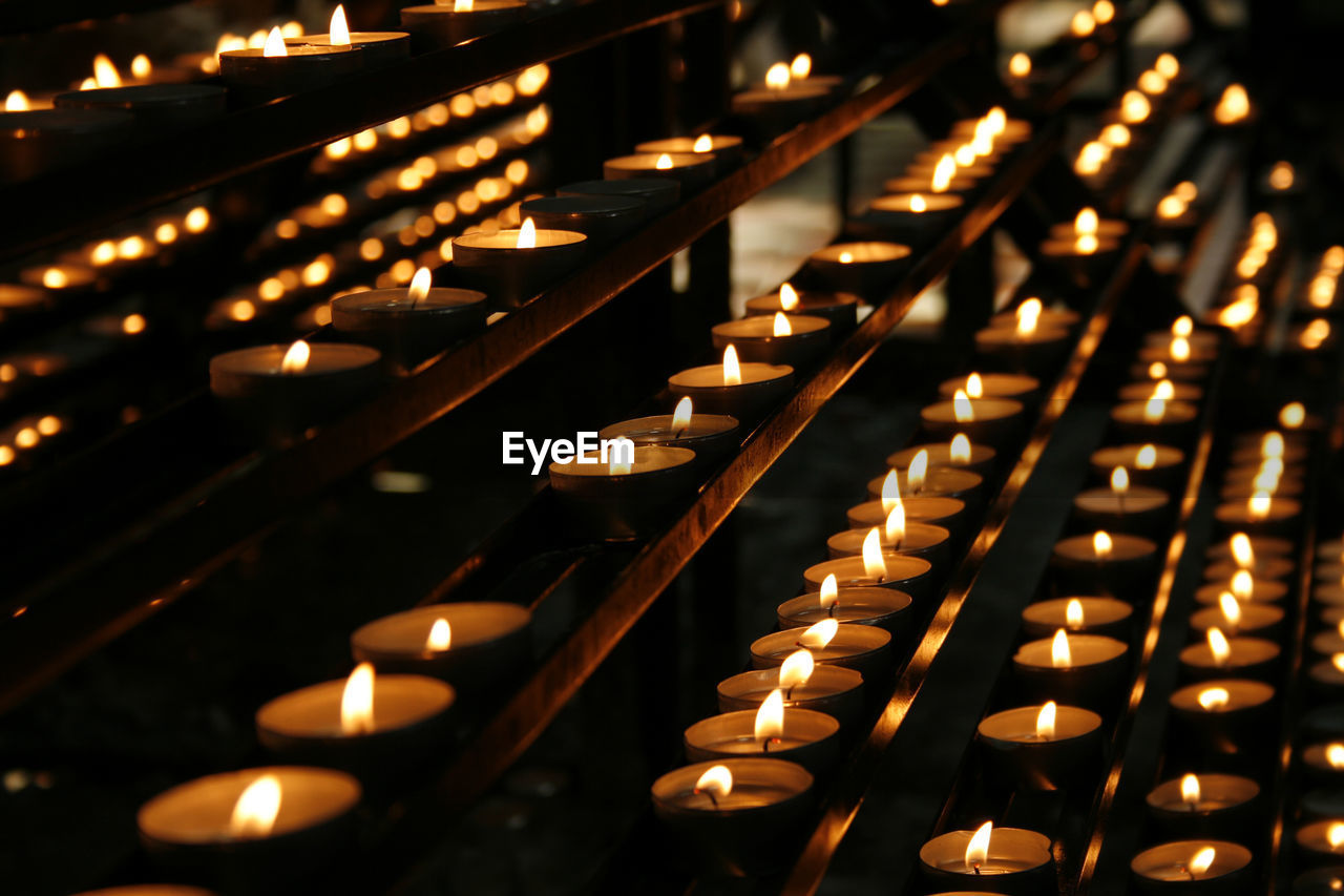 High angle view of lit tea lights