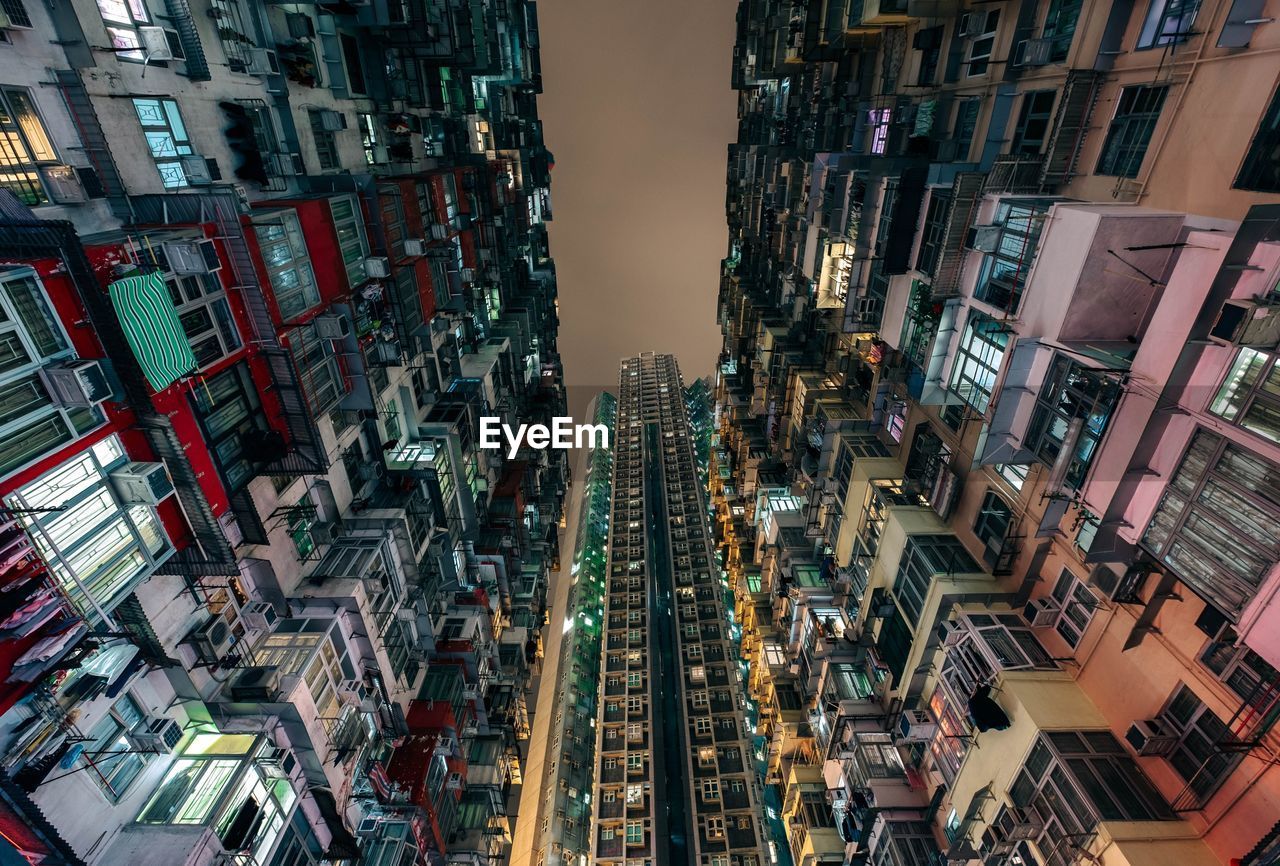 Low angle view of illuminated buildings in city at night