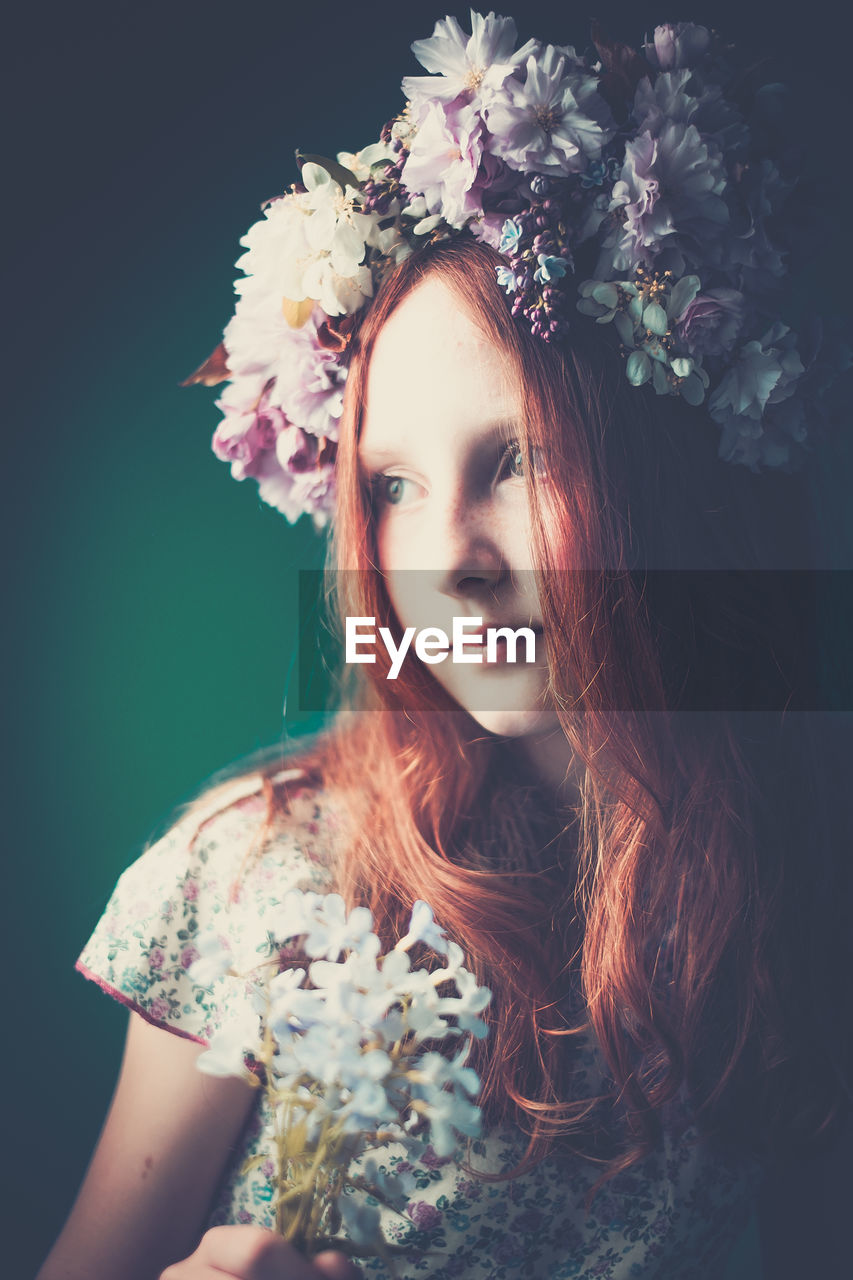 Portrait of young girl wearing floral garland