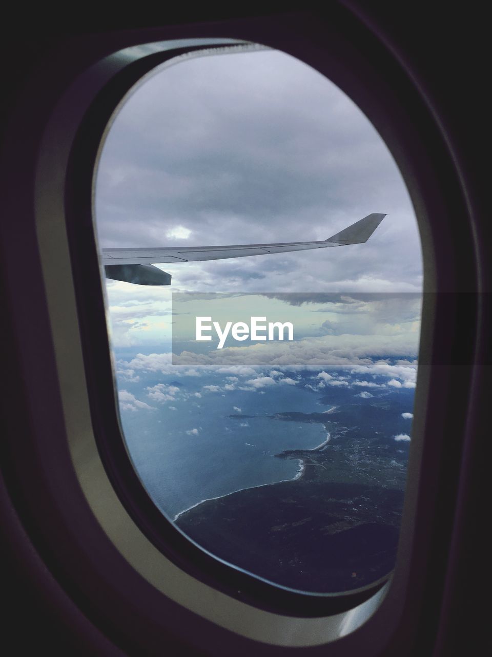 Scenic view of sea seen through airplane window