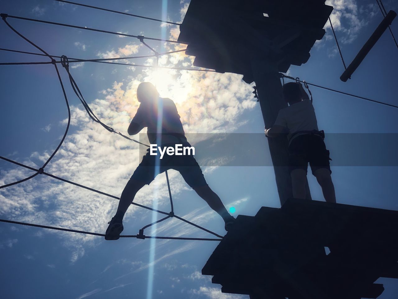 LOW ANGLE VIEW OF SILHOUETTE ROPE AGAINST SKY