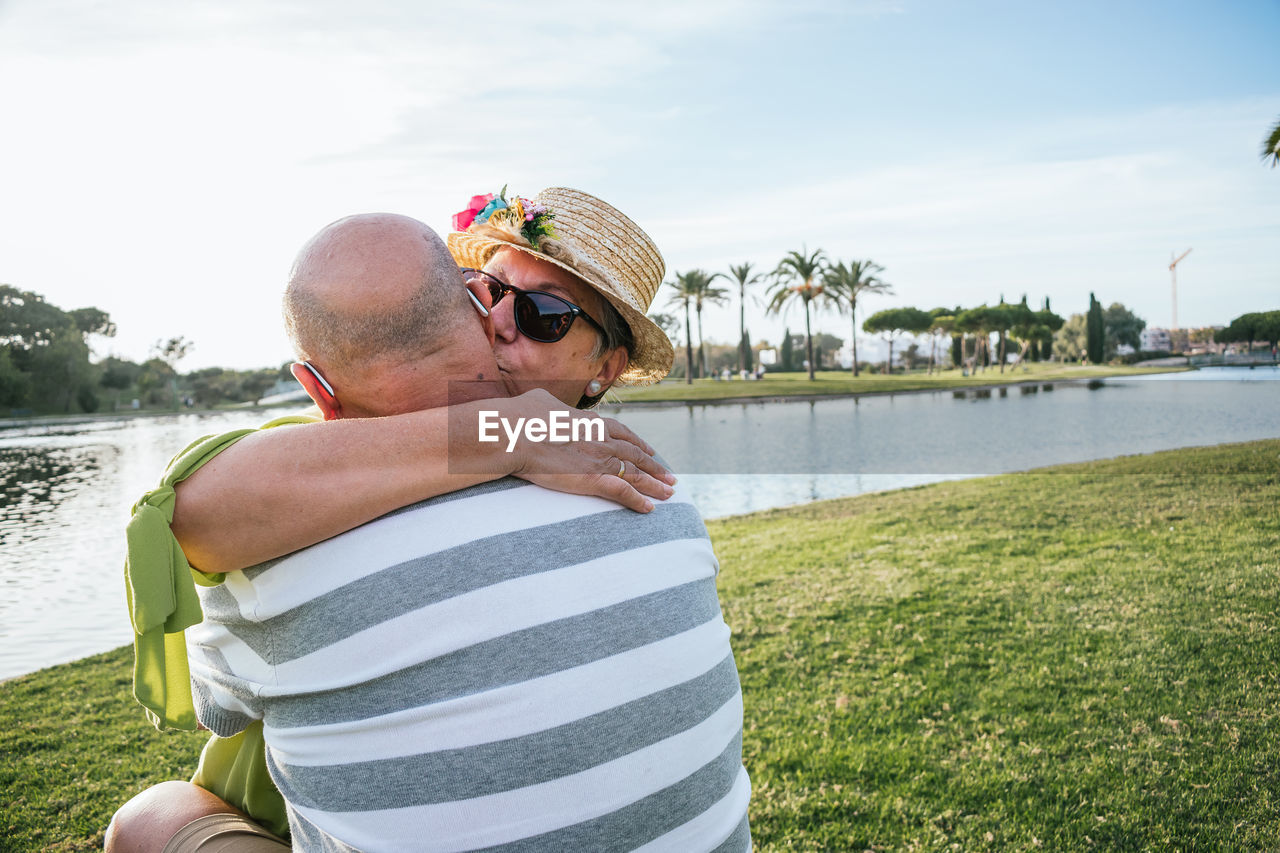 Rear view of couple kissing in water