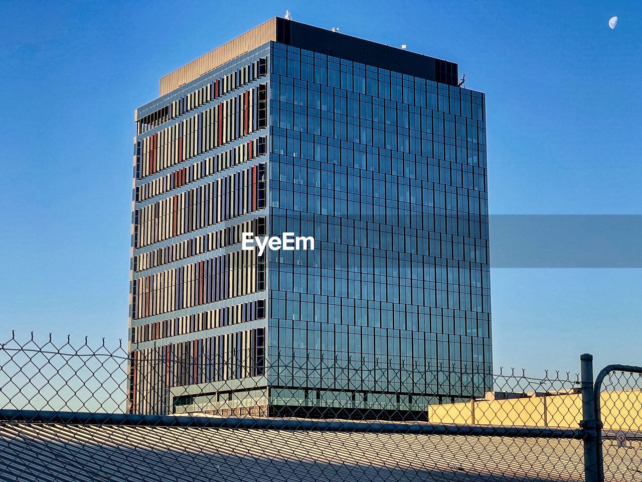 MODERN BUILDING AGAINST CLEAR BLUE SKY