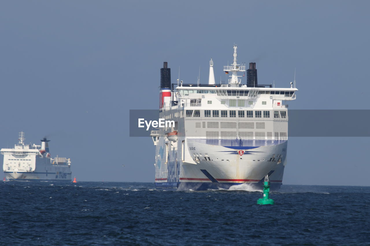 BOAT MOORED AT HARBOR AGAINST CLEAR SKY