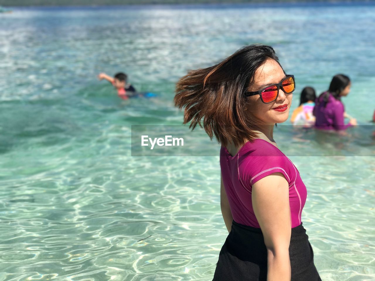 Portrait of woman in sunglasses at beach