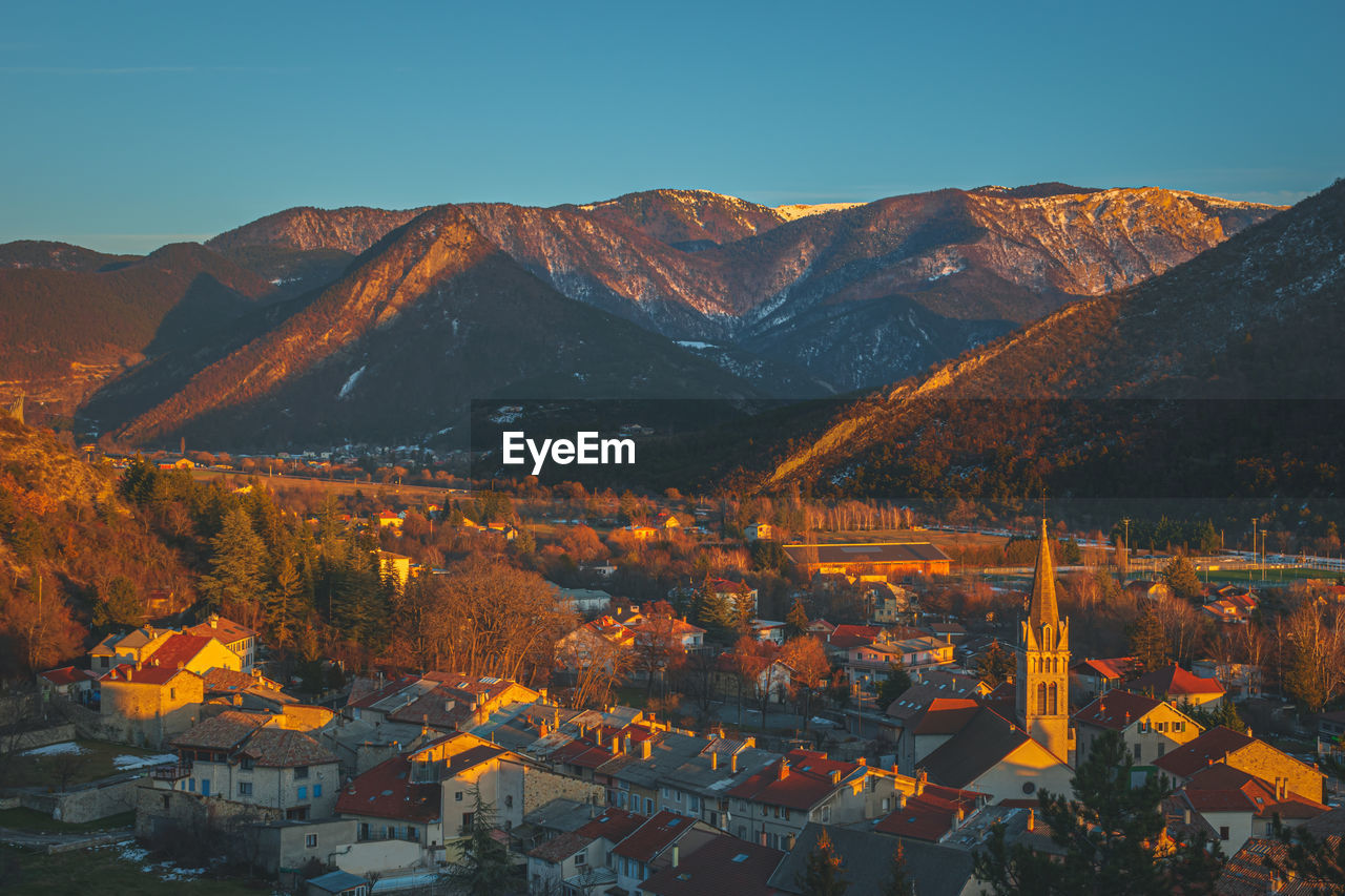 A panoramic wide landscape view of veynes, an old town in the french alps, during the sunset