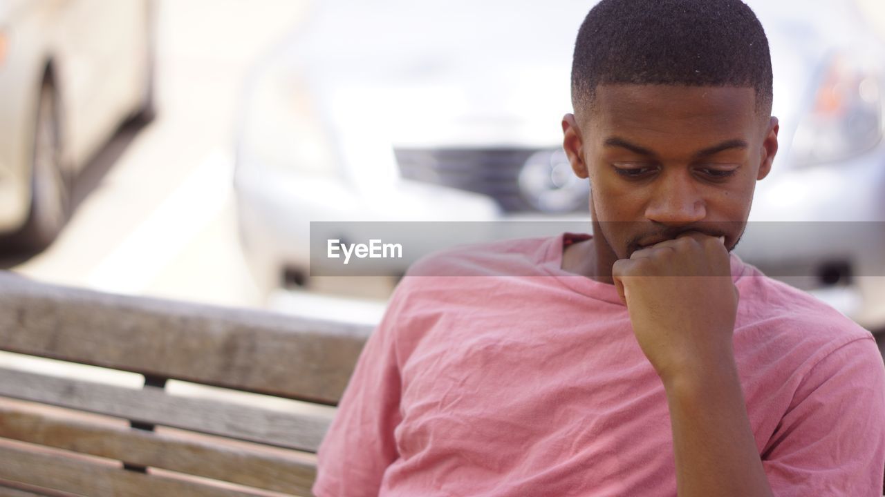 Close-up of thoughtful man sitting on bench