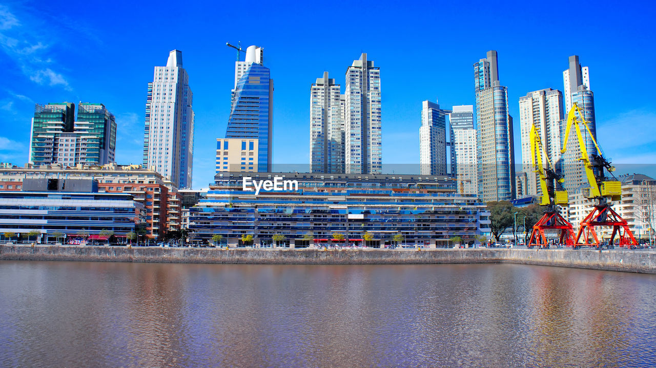 MODERN BUILDINGS AGAINST CLEAR BLUE SKY