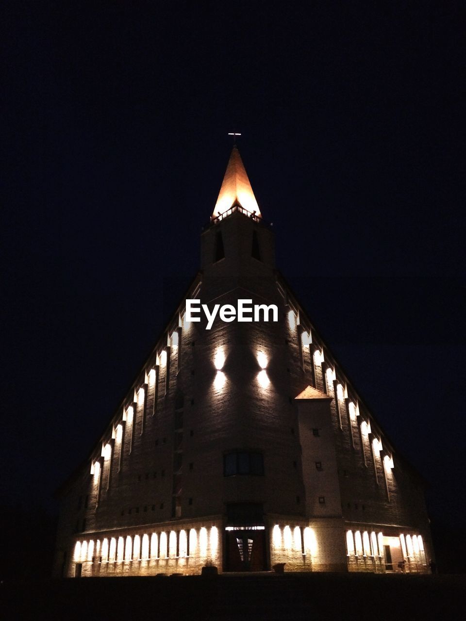 LOW ANGLE VIEW OF ILLUMINATED BUILDING AGAINST SKY