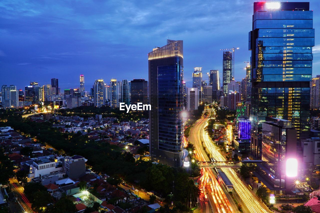 High angle view of city lit up at night