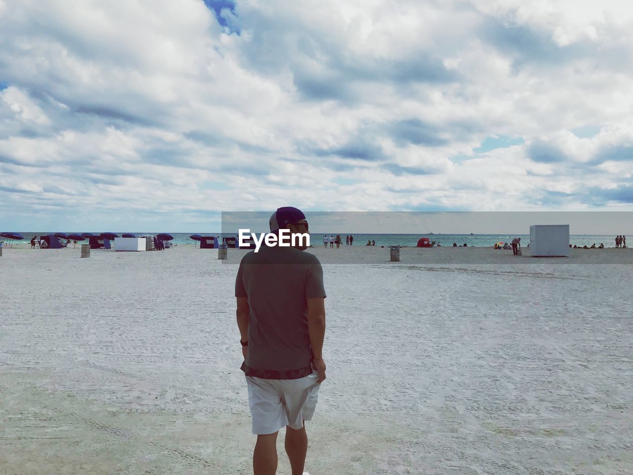 Rear view of man walking at beach