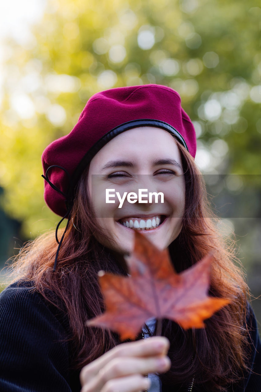 Portrait of a smiling young woman in autumn