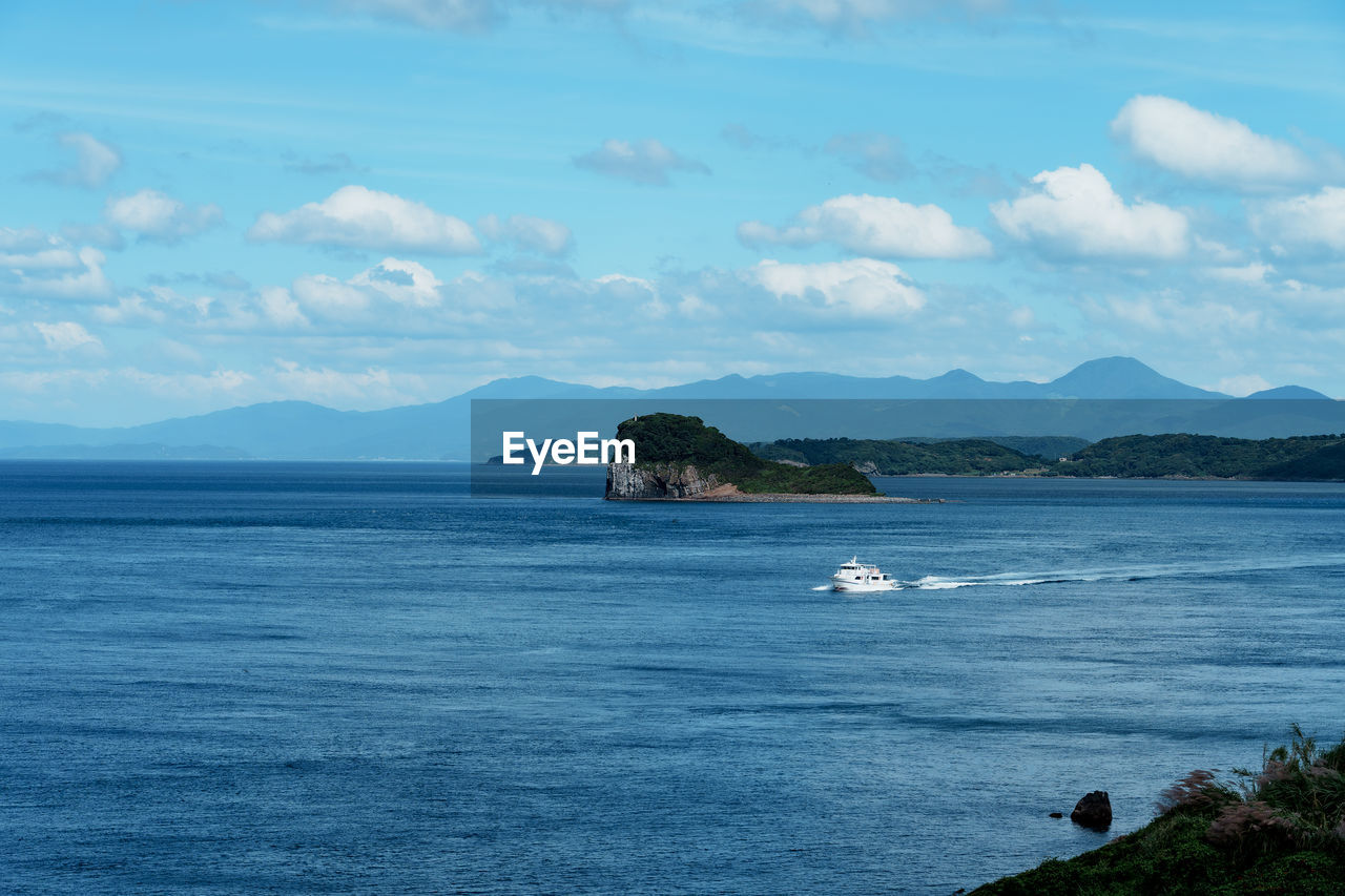 water, sea, sky, horizon, scenics - nature, ocean, body of water, beauty in nature, shore, mountain, coast, land, cloud, nature, tranquil scene, tranquility, no people, bay, beach, day, islet, travel destinations, non-urban scene, travel, island, terrain, blue, outdoors, cove, idyllic, environment, landscape, cliff, rock, transportation, nautical vessel, coastline, mountain range, tourism, wave