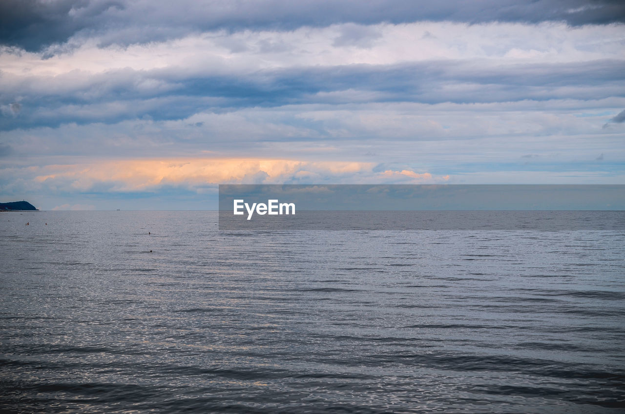 Scenic view of baltic sea against cloudy sky at dusk