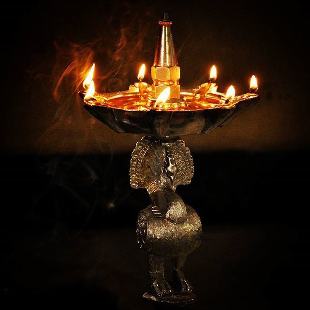 CLOSE-UP OF LIT CANDLE IN ROOM