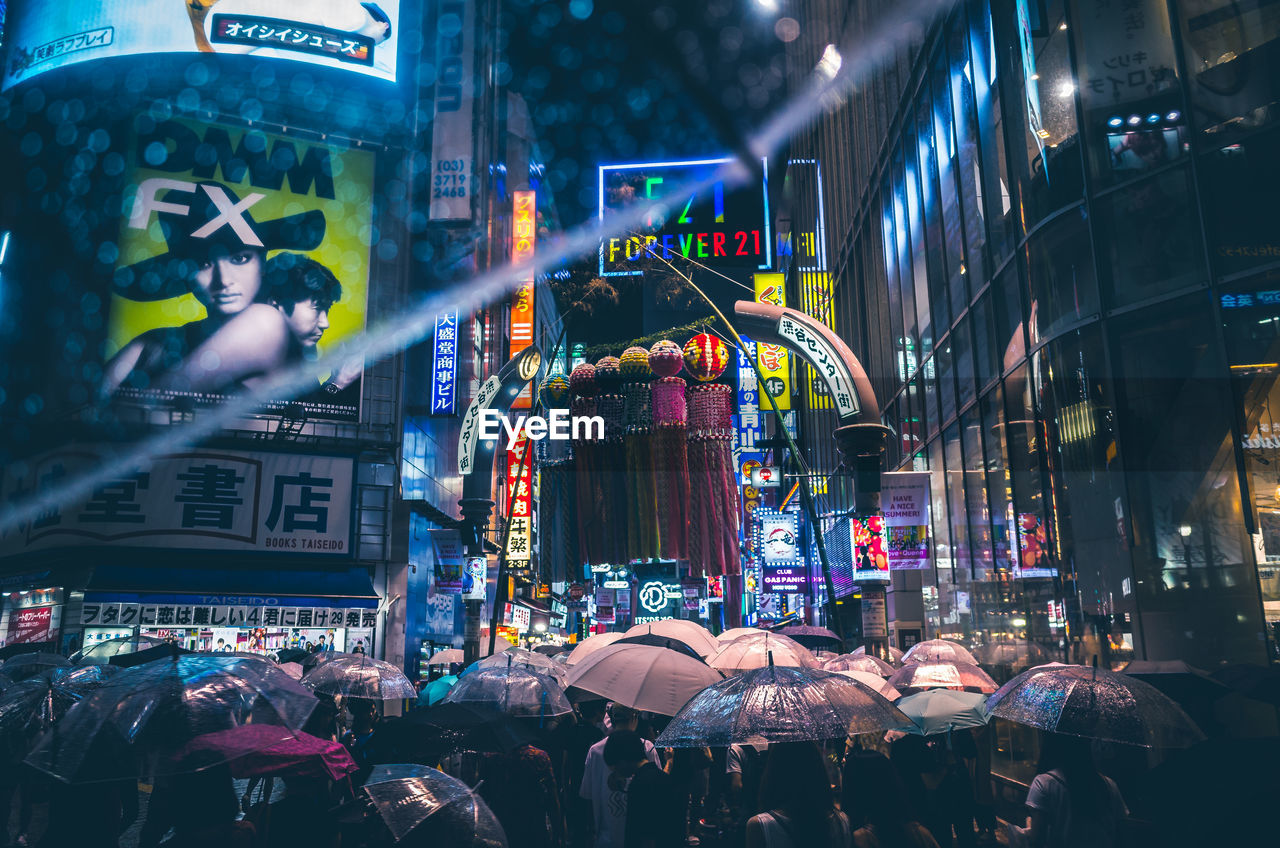 CROWD AT ILLUMINATED CITY