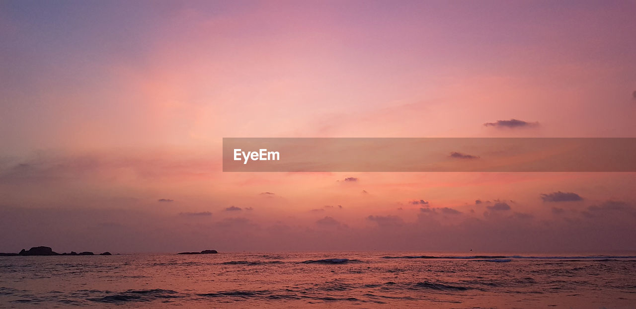 sky, sea, sunset, water, beauty in nature, scenics - nature, nature, land, cloud, environment, tranquility, horizon over water, horizon, beach, dawn, landscape, dramatic sky, afterglow, seascape, travel, tranquil scene, ocean, orange color, sun, travel destinations, evening, idyllic, outdoors, no people, pink, shore, coast, holiday, vacation, urban skyline, sunlight, trip, body of water, tourism, romantic sky, multi colored, reflection, summer, wave, motion, red sky at morning, twilight, red, tropical climate, atmospheric mood, wind wave, awe, sand