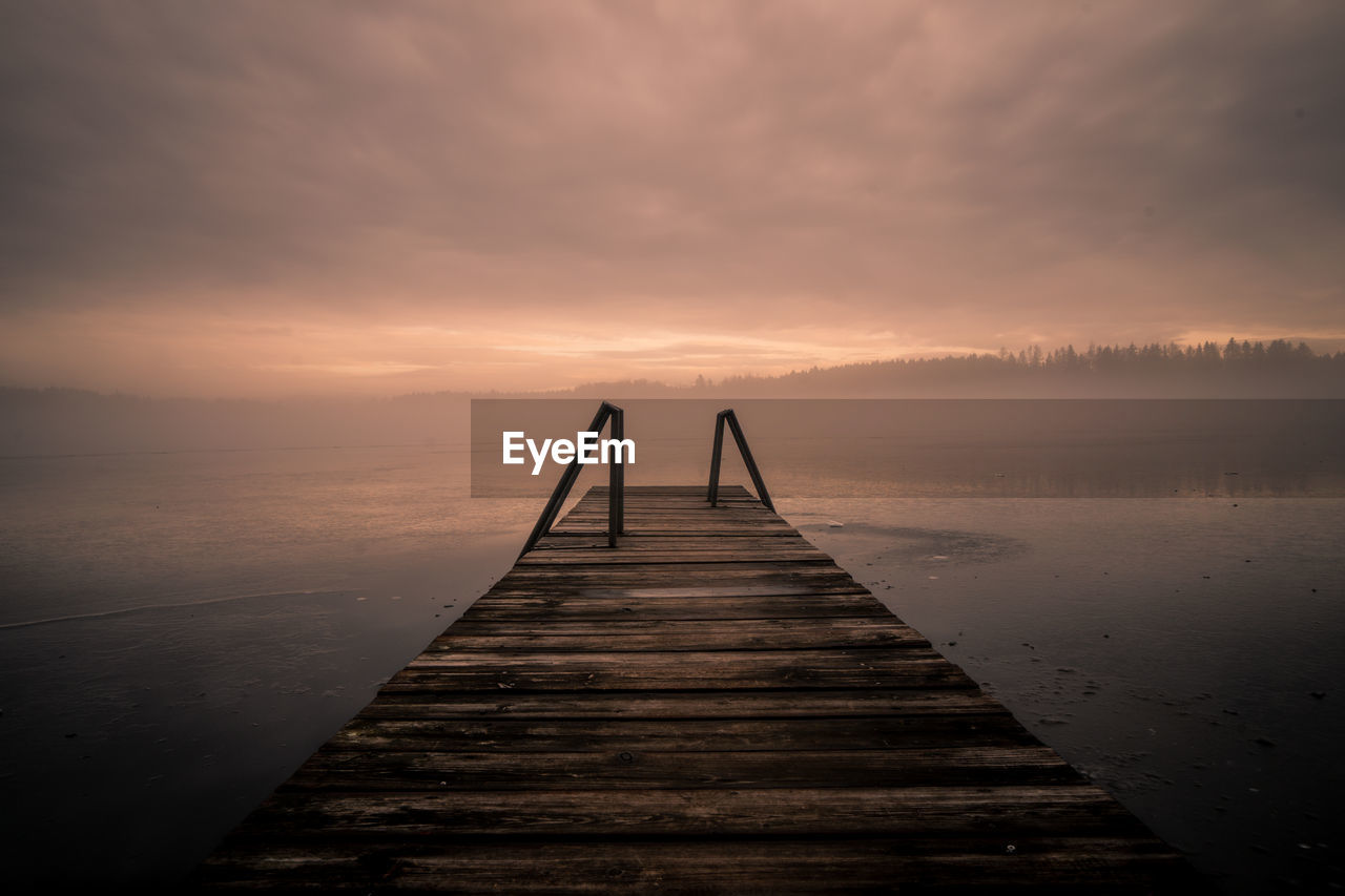 Jetty on the water in the fog