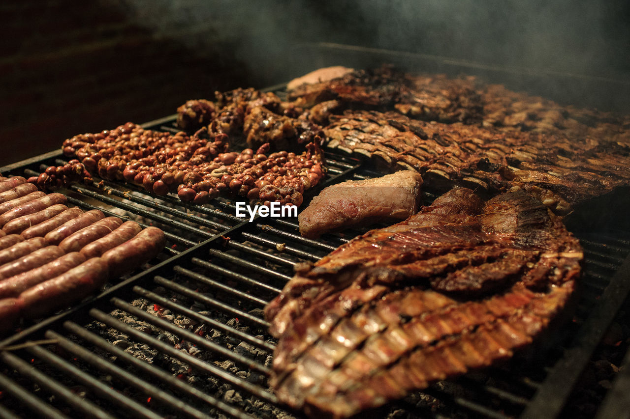 Close-up of meat on barbecue grill at night