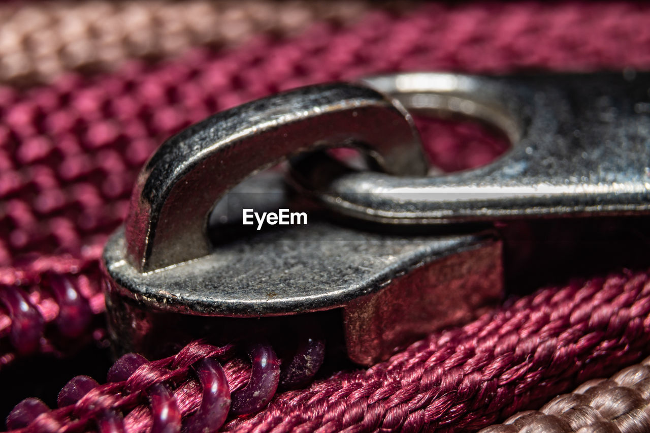 red, close-up, no people, fashion accessory, pink, metal, selective focus, chain, strap, purple, textile, indoors, leather, belt