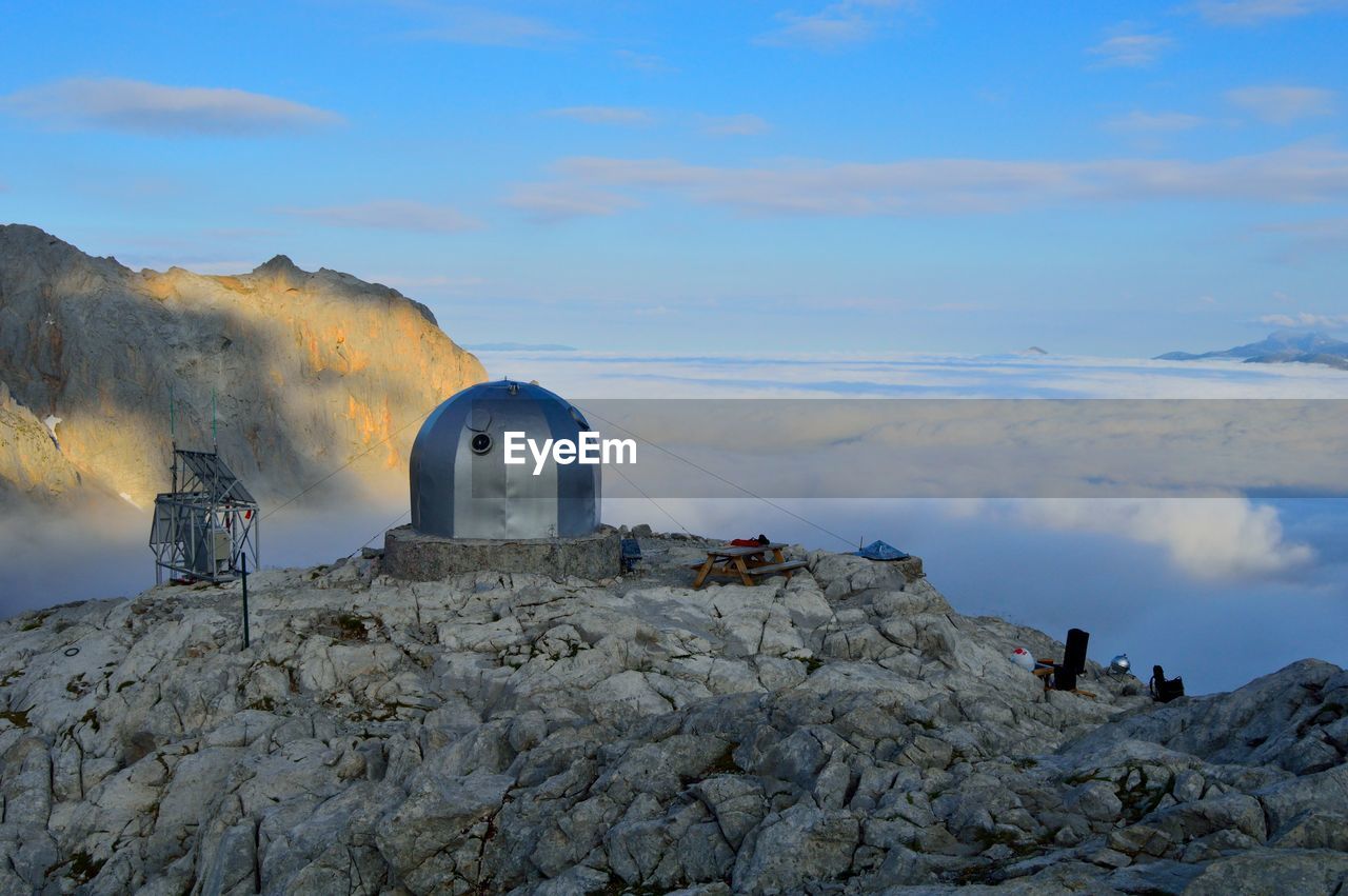 PEOPLE ON ROCKS AGAINST SKY