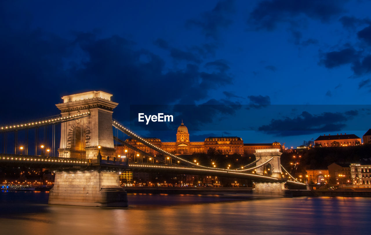 Royal palace or the buda castle and the chain bridge after sunset in budapest in hungary.