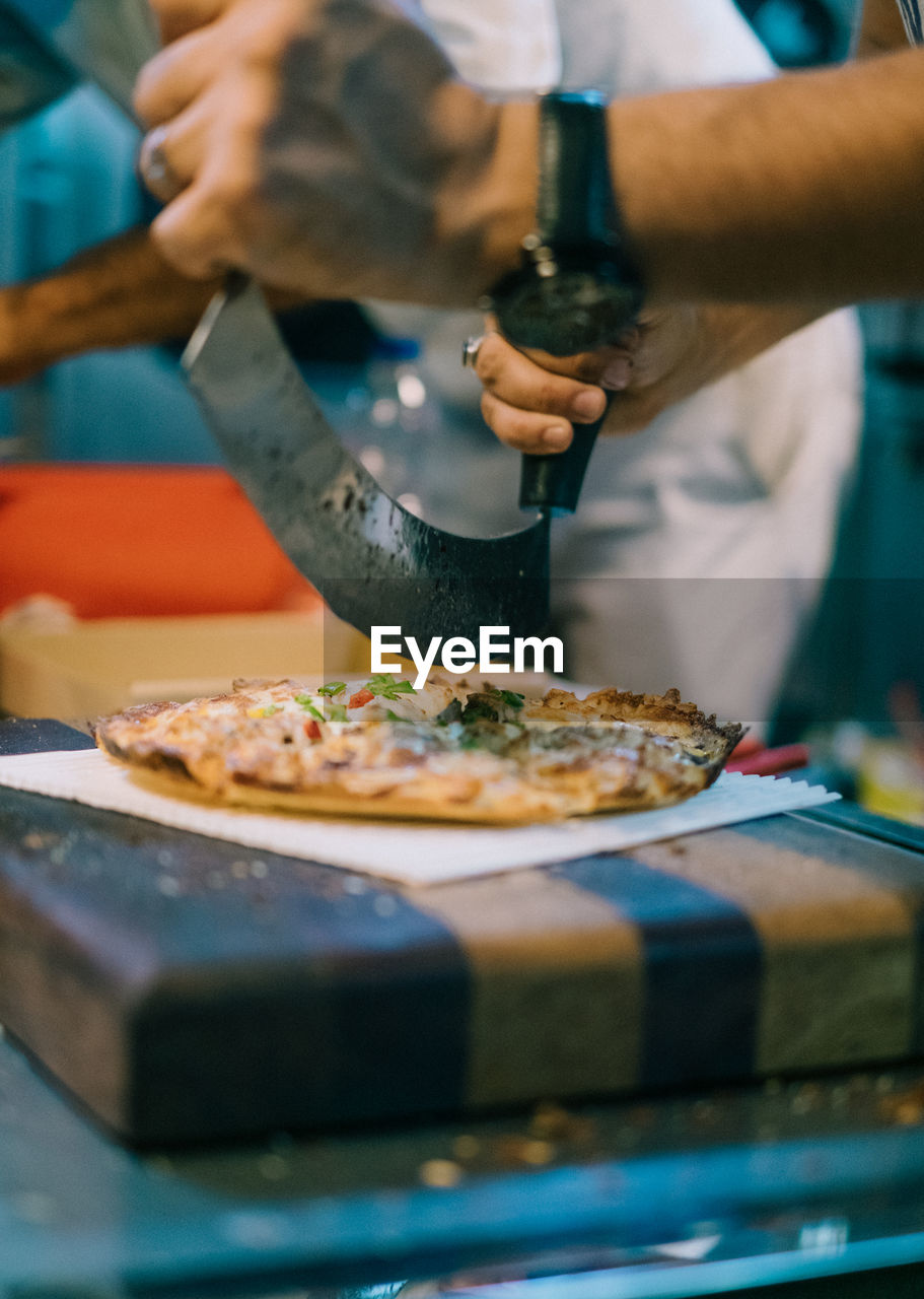 Midsection of man preparing food in restaurant