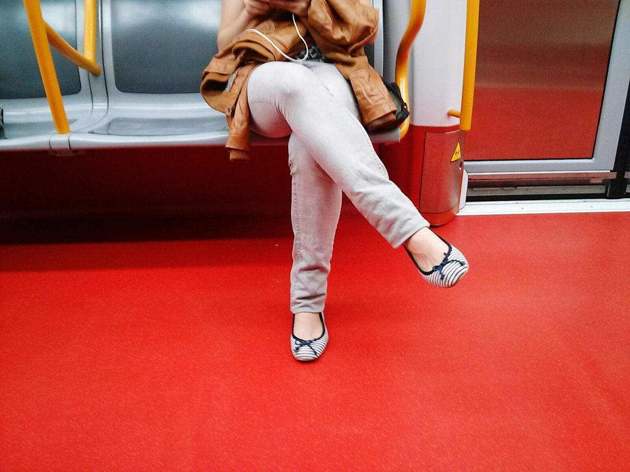 LOW SECTION OF MAN STANDING ON RED MIRROR