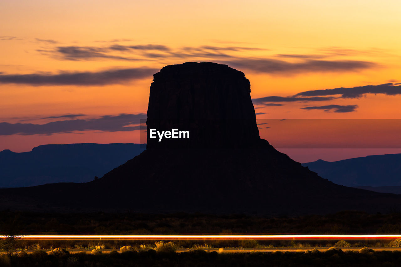 Silhouette of mountain road during sunset