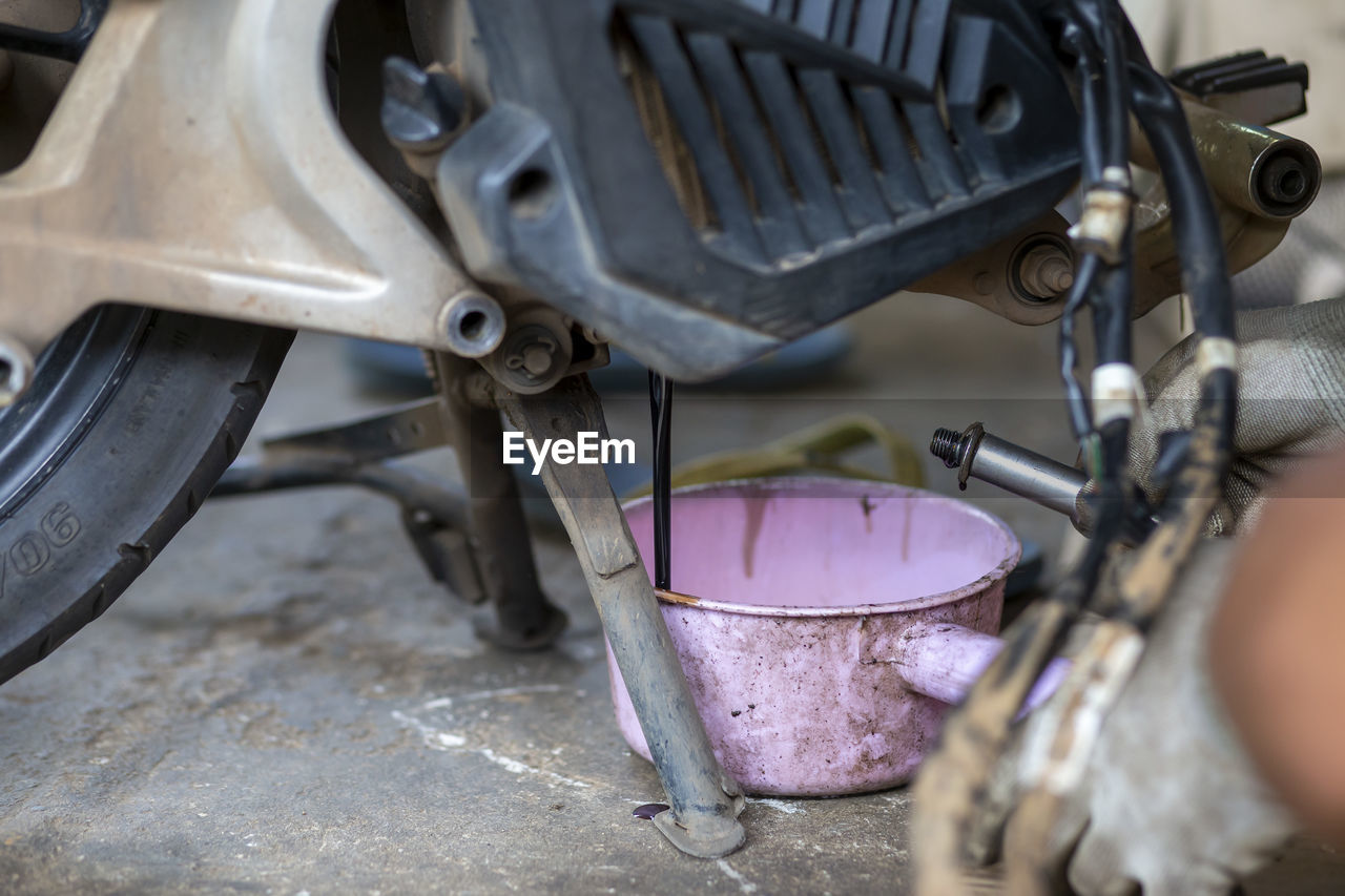 High angle view of worker working on motorcycle