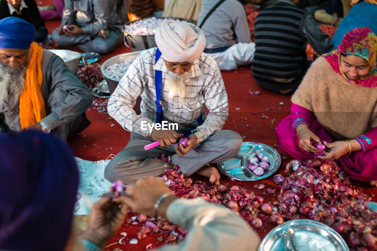 HIGH ANGLE VIEW OF PEOPLE AT STREET MARKET