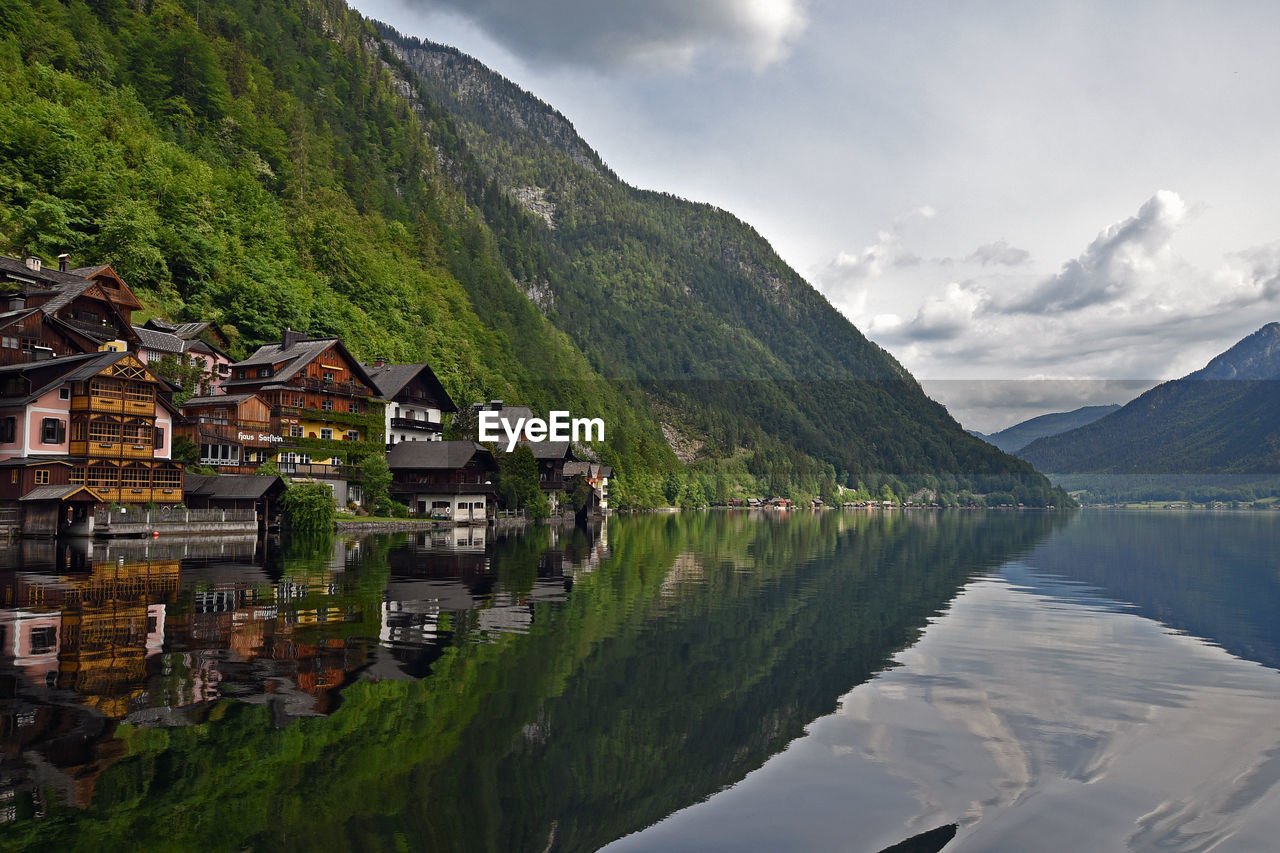 LAKE BY BUILDINGS AGAINST SKY