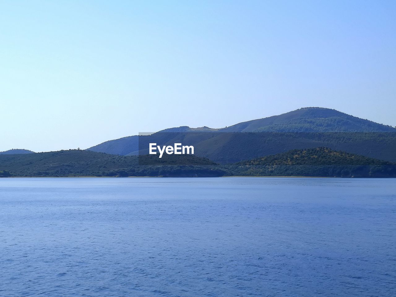 Scenic view of sea against clear blue sky