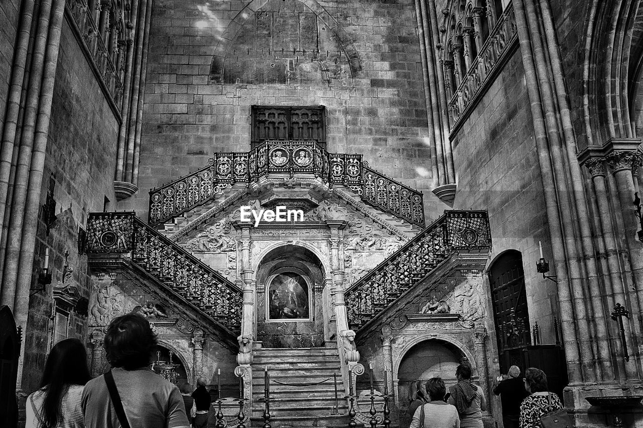 LOW ANGLE VIEW OF PEOPLE WALKING AT TEMPLE