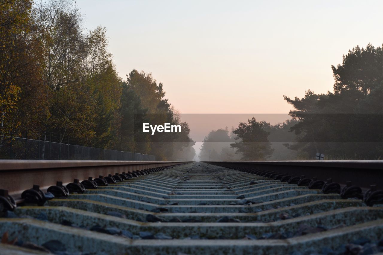 Low angle view of railroad tracks in the fog