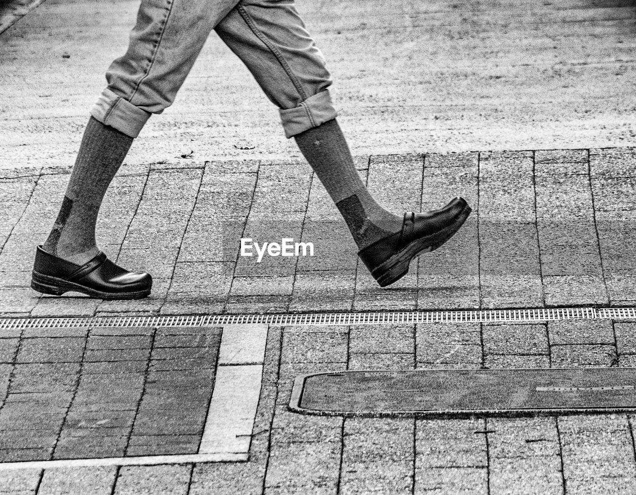 SHADOW OF PEOPLE WALKING ON FOOTPATH