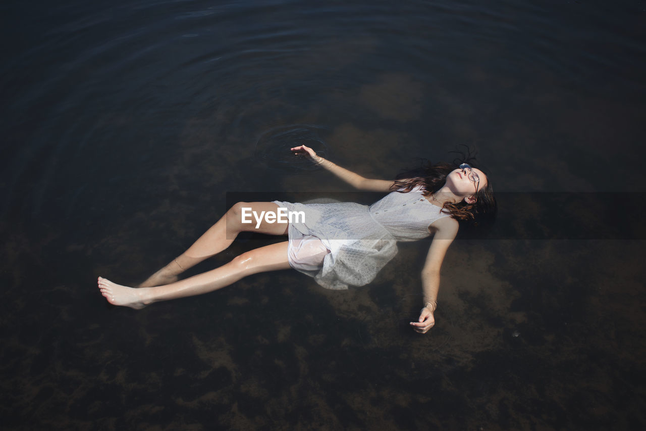 High angle view of woman relaxing in sea