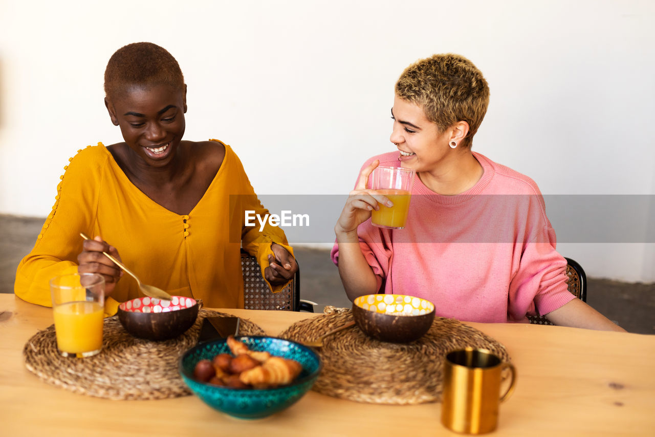 portrait of young woman eating food at home