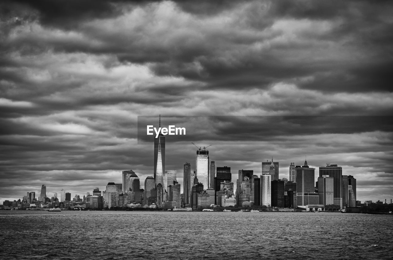 View of skyscrapers against cloudy sky