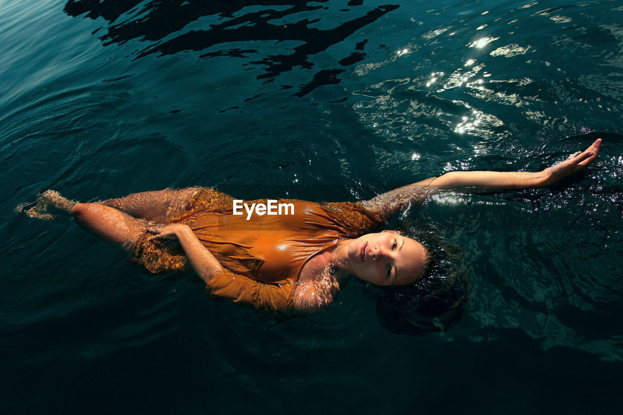 Young woman swimming in water