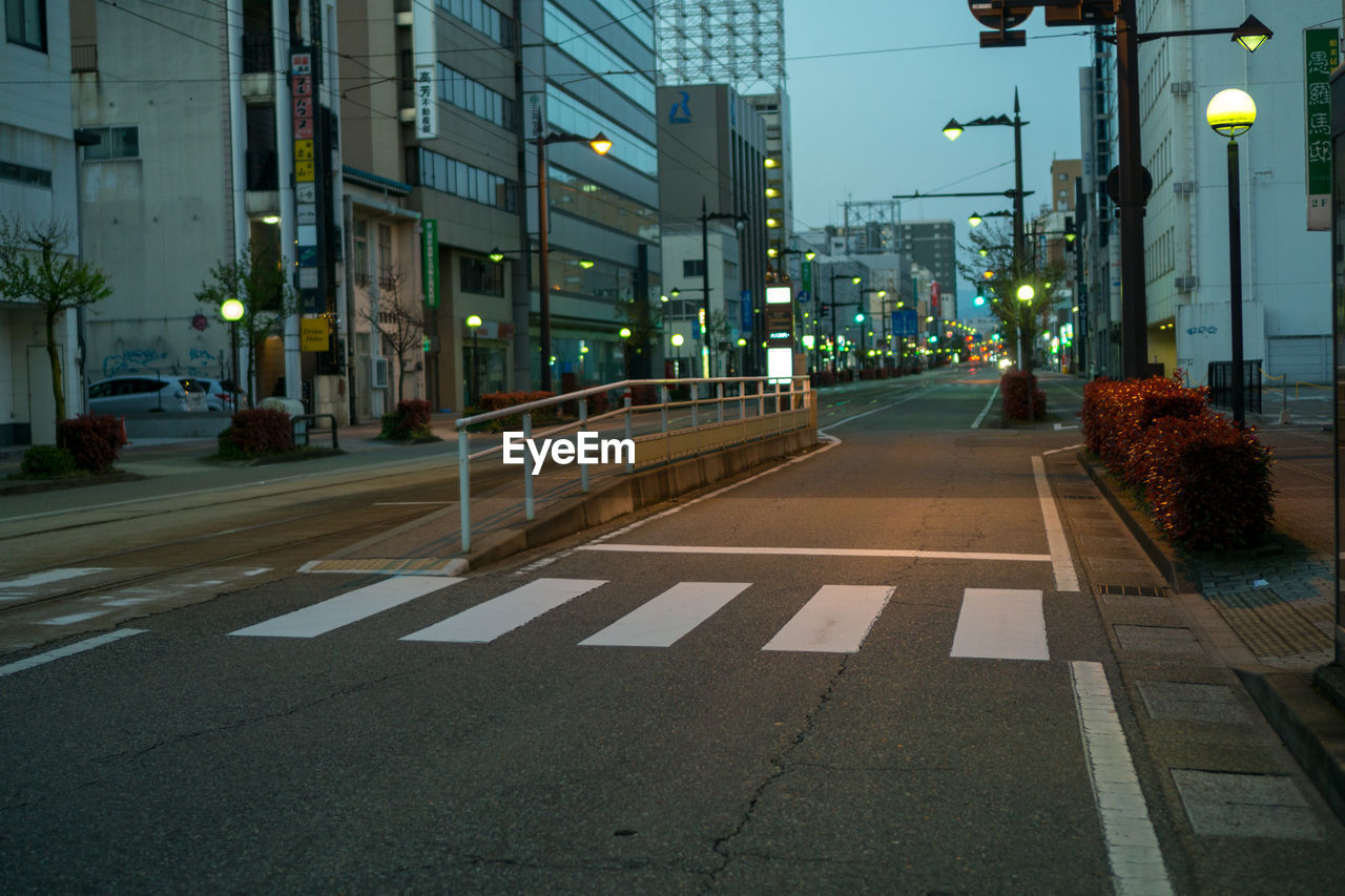 Street amidst buildings at night