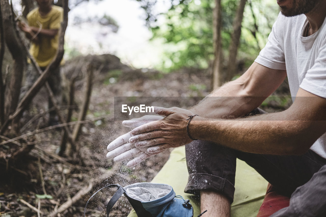 Close up of rock climber hands clapping hands with chalk