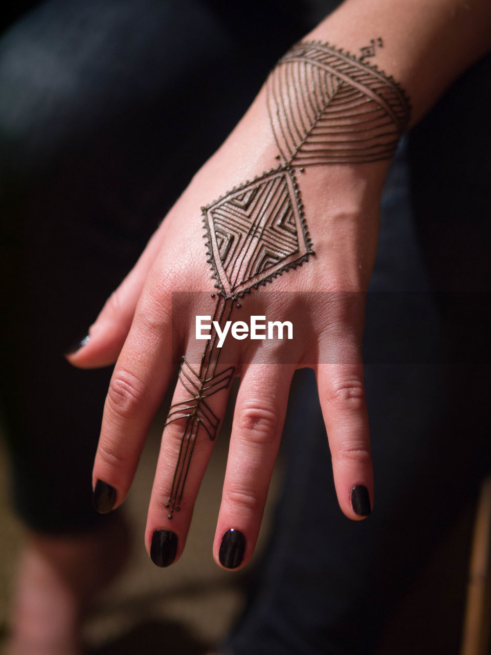 Cropped image of woman hand with henna tattoo