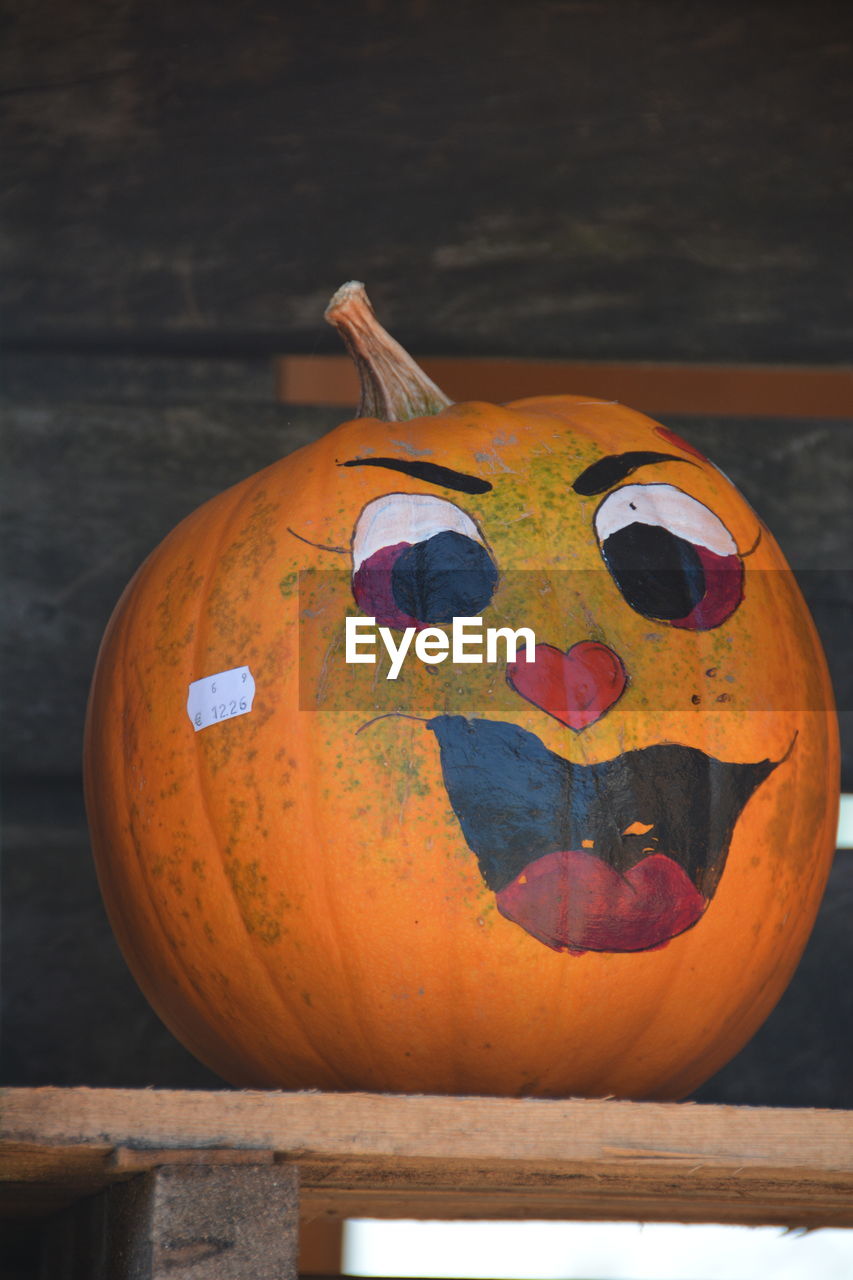 Art made on pumpkins in wooden crate during halloween