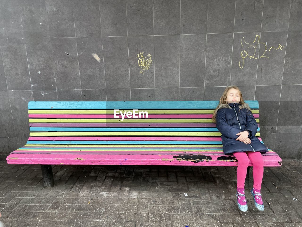 Rear view of man sitting on bench