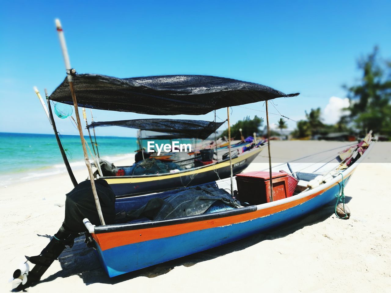 BOATS MOORED AT BEACH