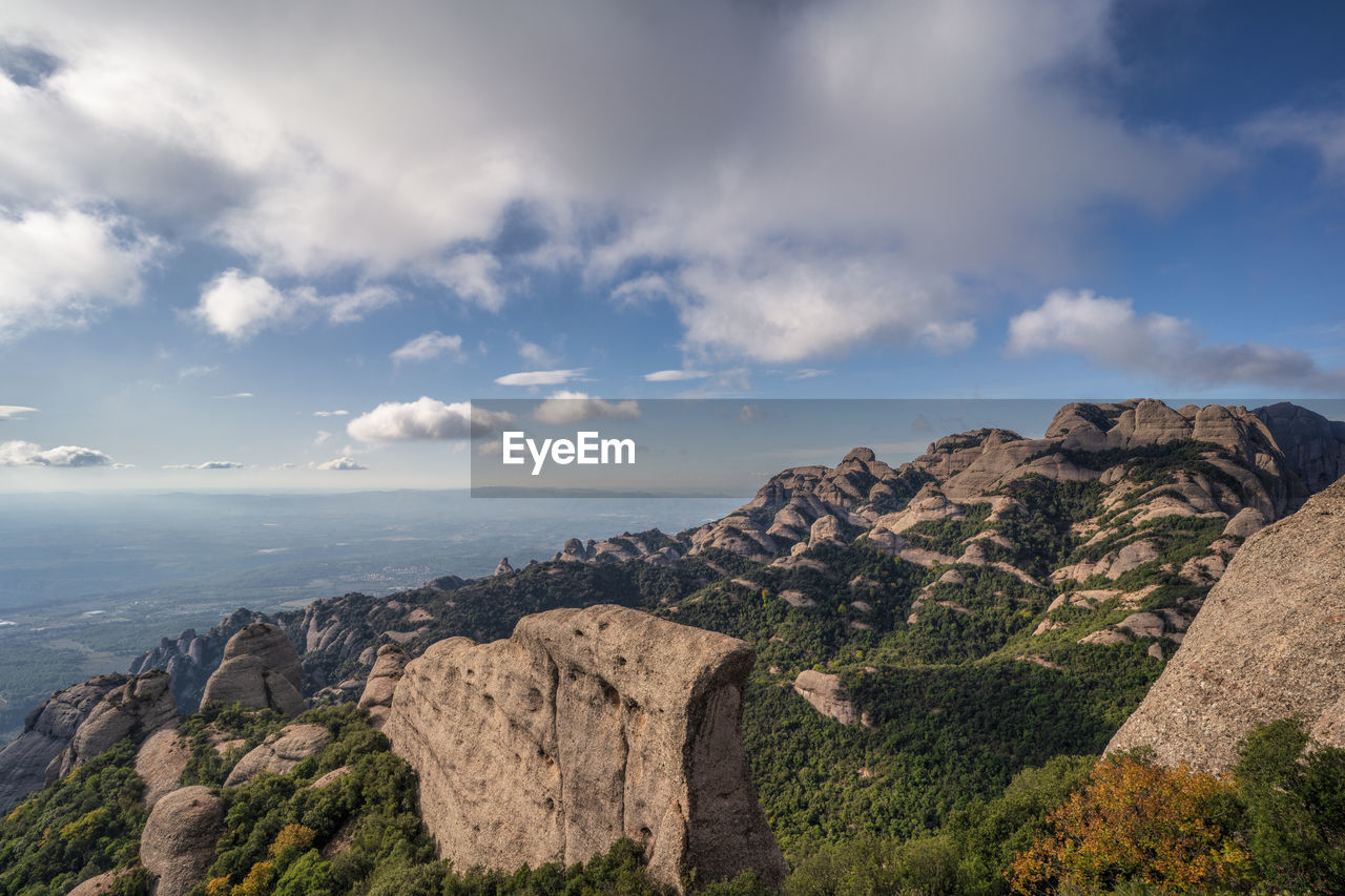 PANORAMIC VIEW OF ROCKS AND MOUNTAINS AGAINST SKY