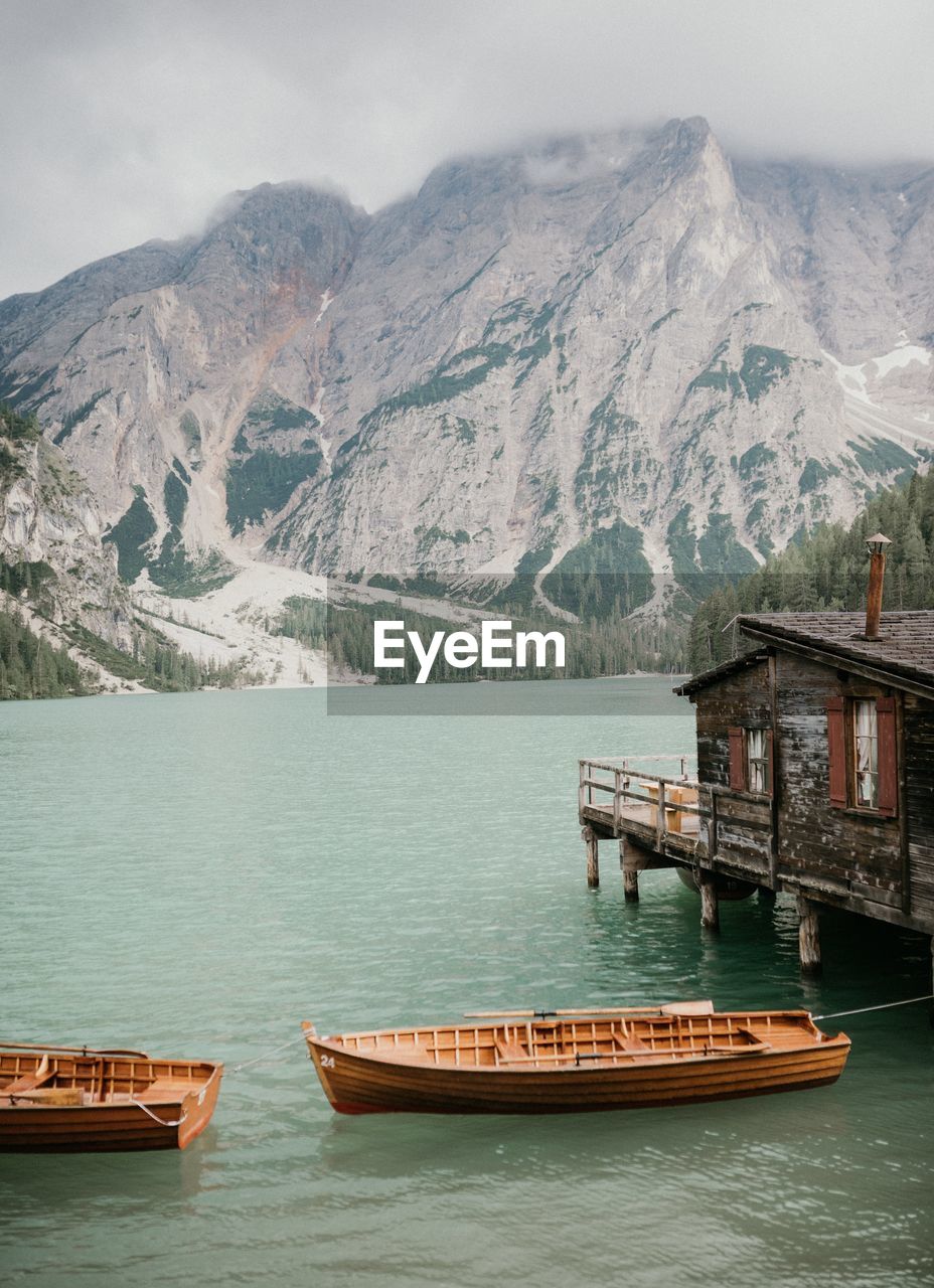 Scenic view of lake by mountains against sky