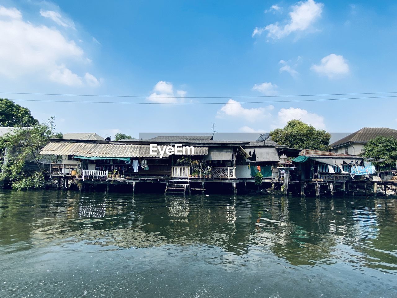 HOUSES BY RIVER AGAINST BUILDINGS